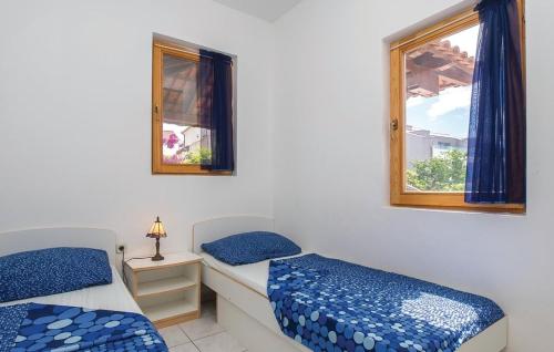 a bedroom with two beds and a window at Apartments by the sea Sutivan, Brac - 15617 in Sutivan