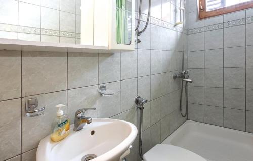 a bathroom with a sink and a toilet and a shower at Apartments by the sea Sutivan, Brac - 15617 in Sutivan