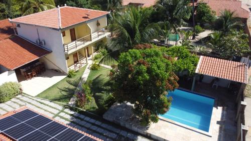 an aerial view of a house with solar panels at Pousada Villa Manduca in Amontada