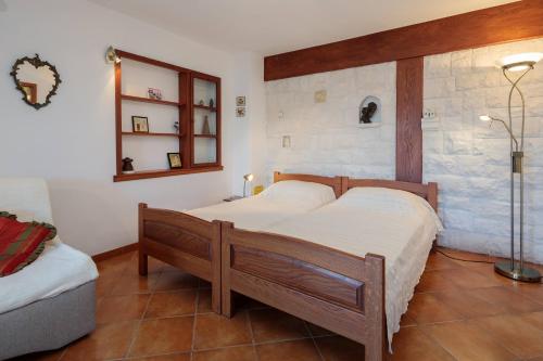 a bedroom with two beds and a mirror at Apartments with parking space Supetar, Brac - 15640 in Supetar