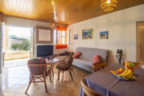 a living room with a couch and a table at Apartments by the sea Okrug Donji, Ciovo - 15655 in Okrug Donji