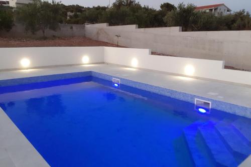 a swimming pool with lights on top of a house at Apartment Sevid 15664a in Sevid