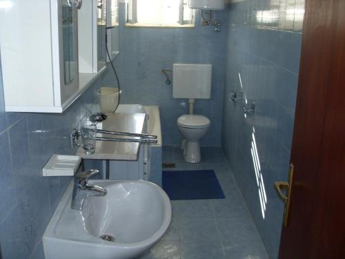 a bathroom with a sink and a toilet at Apartments by the sea Korcula - 15689 in Korčula