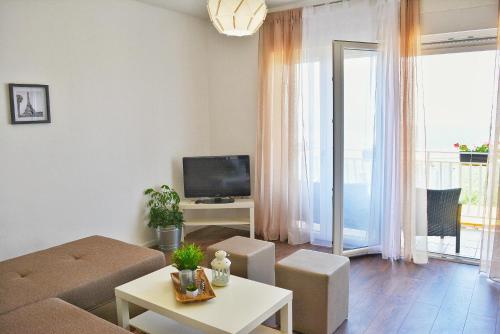 a living room with a couch and a tv at Apartments with a parking space Smrika, Kraljevica - 15700 in Šmrika