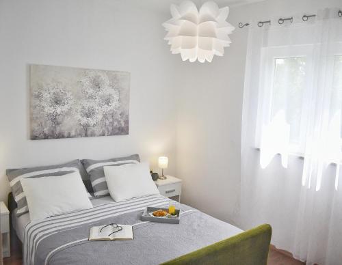 a bedroom with a bed with a tray of fruit on it at Apartments with a parking space Smrika, Kraljevica - 15700 in Šmrika