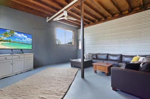 a living room with a couch and a flat screen tv at Hygge House - Calm & Cosy Escape in Nature in Nungurner