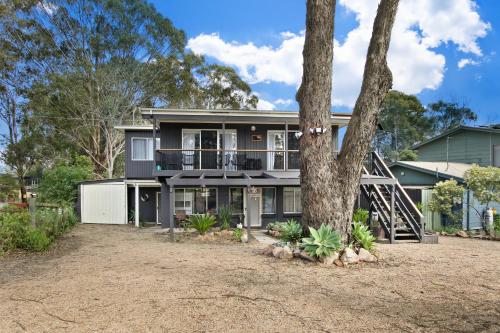 a house with a tree in front of it at Hygge House - Calm & Cosy Escape in Nature in Nungurner