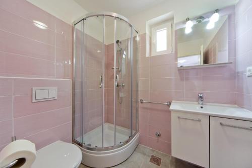 a bathroom with a shower and a toilet and a sink at Apartments by the sea Nerezine, Losinj - 15778 in Nerezine