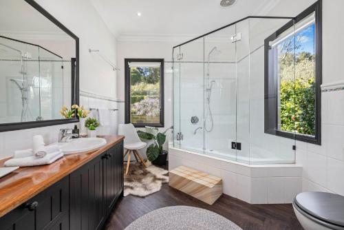 a bathroom with a shower and a sink at Sandstone Estate in Red Hill