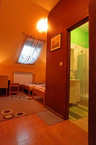 a room with a door to a room with a bathroom at Rooms with a parking space Osijek, Slavonija - 15994 in Osijek