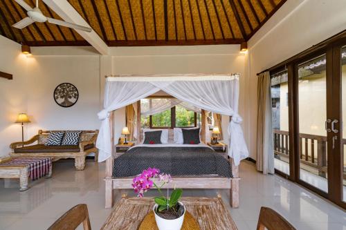 a bedroom with a bed in a room at The Dayuh Ubud in Ubud