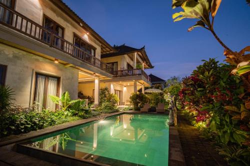 an image of a villa with a swimming pool at night at The Dayuh Ubud in Ubud
