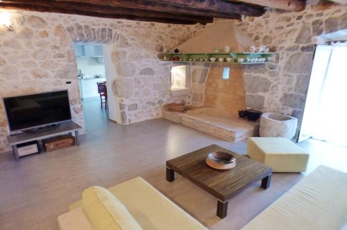 a living room with a couch and a table at Holiday house with a parking space Skrbcici, Krk - 16084 in Vrh