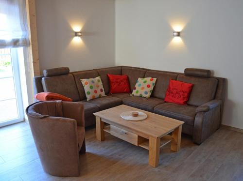 a living room with a couch and a coffee table at Aloha in Greetsiel