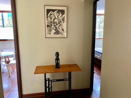 a table in a room with a picture on the wall at Lima Mini Aparts Monterrico - Cerca Embajada EEUU in Lima