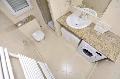 a bathroom with a sink and a toilet at Seaside holiday house Baska Voda, Makarska - 16138 in Baška Voda