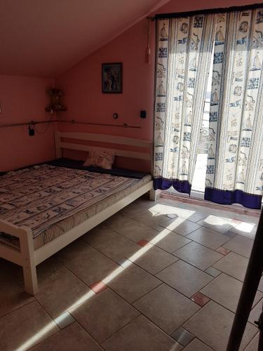 a bedroom with a bed in a room with windows at Apartments by the sea Baric Draga, Karlobag - 16148 in Barić Draga