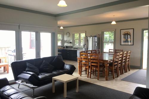 a living room with a couch and a table at By The Bay in Queenscliff