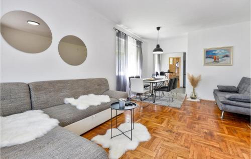 a living room with a couch and a table at Nice Home In Krizevci in Križevci