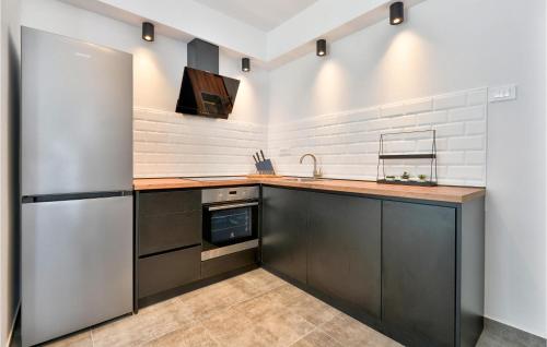 a kitchen with a stainless steel refrigerator and a sink at Nice Home In Krizevci in Križevci