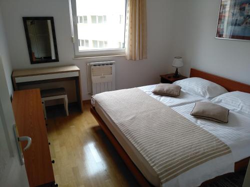 a bedroom with two beds and a fireplace and a window at Apartments with a parking space Krapinske Toplice, Zagorje - 16290 in Krapinske Toplice