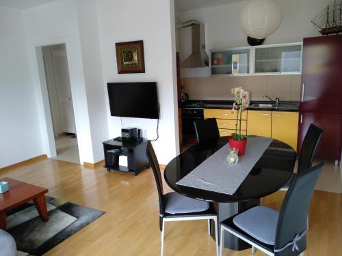 a living room with a black table and chairs at Apartments with a parking space Krapinske Toplice, Zagorje - 16290 in Krapinske Toplice
