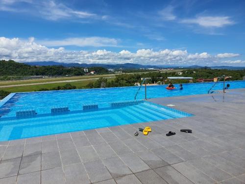 a large blue swimming pool with people in it at deCore in Kota Kinabalu