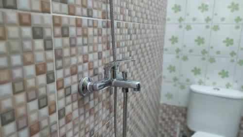 a shower in a bathroom with a toilet at RedDoorz near RSUD Kebumen 2 in Wanasari