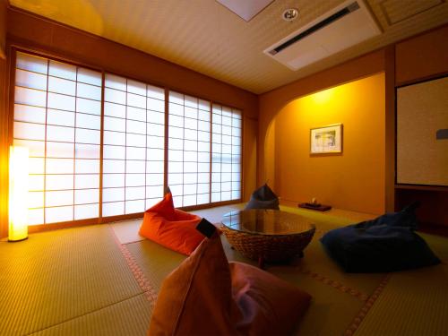 a living room with a room with large windows at Iki Stellacote Taiankaku in Iki