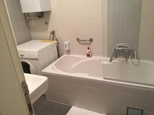 a bathroom with a tub and a toilet and a sink at Apartments with WiFi Zagreb - 16284 in Zagreb