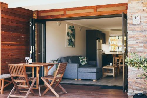 a living room with a couch and a table at The Anchorage Bermagui in Bermagui