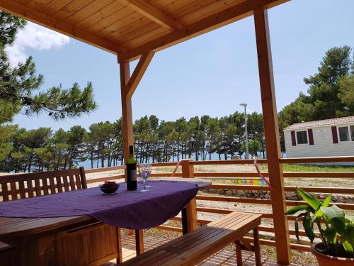 un tavolo con una bottiglia di vino seduto su una terrazza di Apartments by the sea Zivogosce - Blato, Makarska - 16083 a Igrane