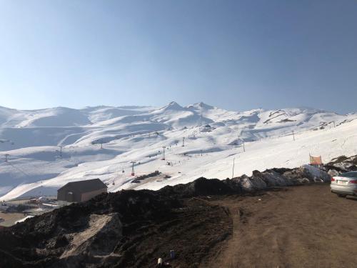 a snow covered mountain with a ski slope at Departamento residencial Valle Nevado in Lo Barnechea