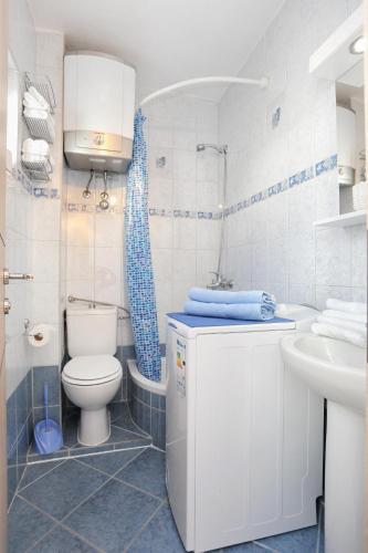 a bathroom with a toilet and a sink at Apartments by the sea Arbanija, Ciovo - 15595 in Trogir