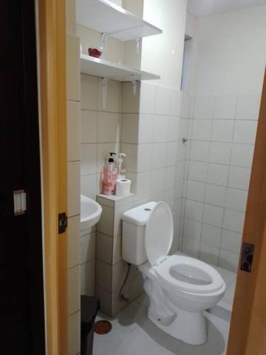 a bathroom with a white toilet and a sink at Affordable Condo for Rent in Valley Mansions in Cainta