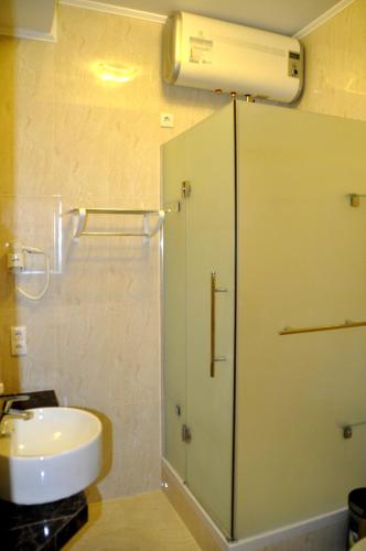 a bathroom with a shower and a toilet and a sink at Hotel Classic in Kyiv