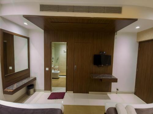 a bathroom with a sink and a mirror at Hotel City Heart Shirdi in Shirdi