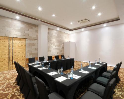 a meeting room with a long table and chairs at Solea Mactan Resort in Mactan