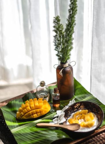a tray with a plate of food on a table at Solea Mactan Resort in Mactan