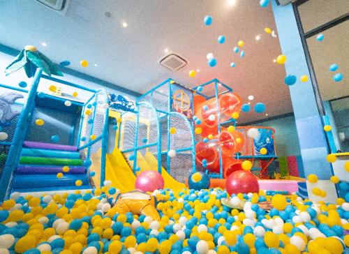 a play room with a bunch of balls and a playground at Solea Mactan Resort in Mactan