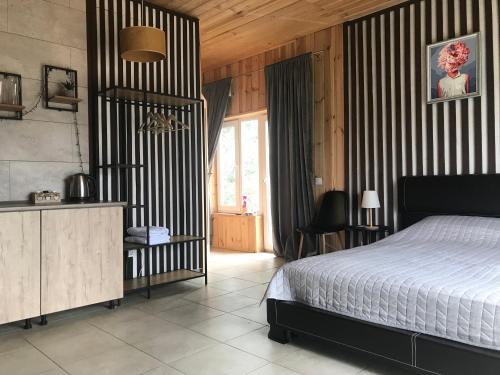a bedroom with a bed and a large window at Relax villa Poduzska in Sinyak