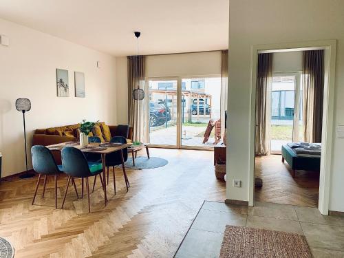 uma sala de estar com uma mesa e um sofá em Modernes Apartment am See mit Terrasse em Grossräschen
