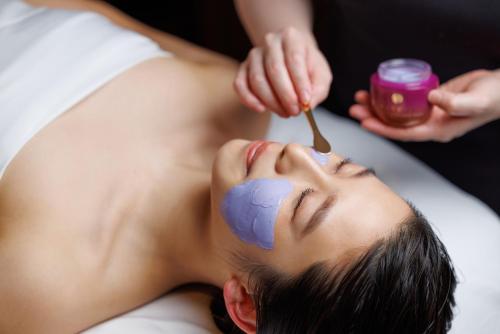 a woman getting a massage at a spa at Four Seasons Hotel Kyoto in Kyoto