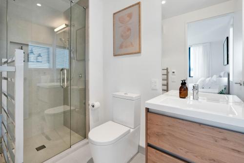 a bathroom with a toilet and a sink and a shower at Top Floor Luxury City Central w Sunny Balcony in Christchurch