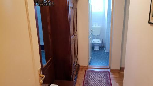 an open door to a bathroom with a toilet at Rooms by the sea Rava, Dugi otok - 15880 in Rava