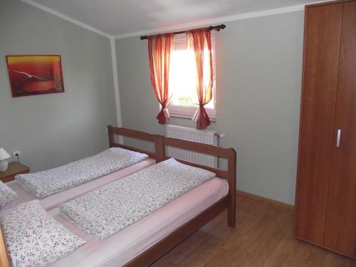 two beds in a small room with a window at Apartments with a parking space Novi Vinodolski - 15823 in Novi Vinodolski