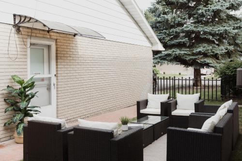 eine Terrasse mit schwarzen Korbstühlen und einem Tisch in der Unterkunft Modern, Luxurious Apartment near Downtown Ottawa in Ottawa