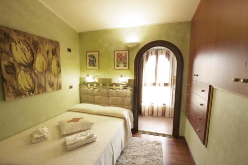 a bedroom with a bed and a window and a mirror at B&B La Dolce Vita in Flumini di Quartu