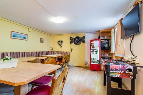 a dining room with a table and chairs and a tv at Alpenpension Elferblick in Neustift im Stubaital