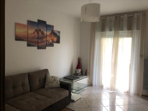 a living room with a couch and a window at Casa di Max - private room in apartment with shared bathroom FREE PARKING in Bolzano